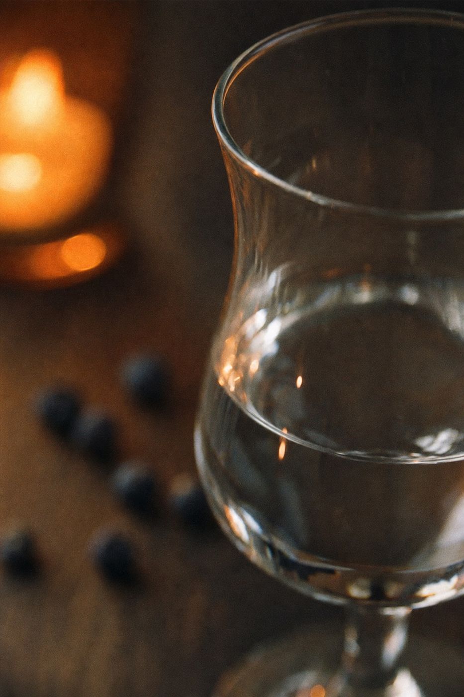 Een jeneverglas in kaarslicht